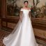 Model wears an off the shoulder A-line Satin Wedding Dress called Tucana by Bridal Gown Designer Pronovias available at Romantique Bridal Magherafelt Northern Ireland