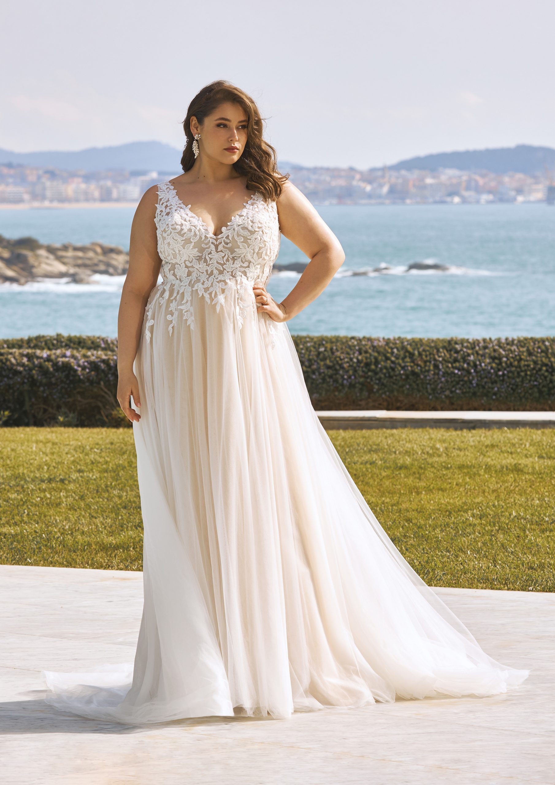 Model wears a 2023 PLUS-SIZE Wedding Dress called LAVINIA by Top Spanish Bridal Gown Designer Pronovias available at Romantique Bridal Magherafelt Northern Ireland