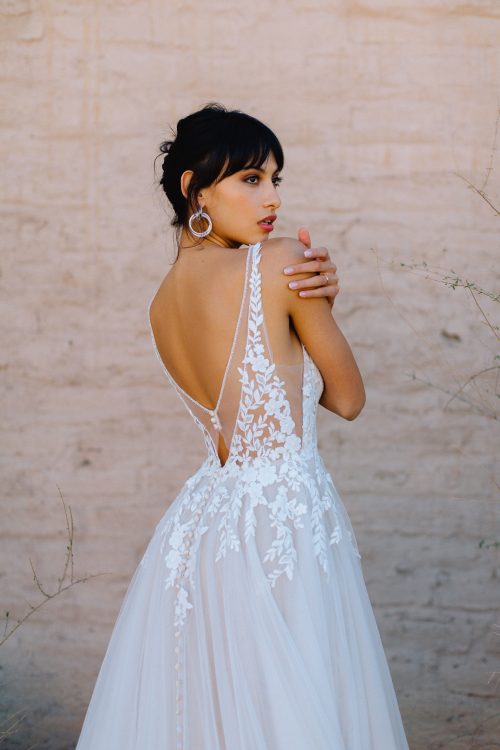 Beautiful Romantic and Lightweight Wedding Dress. Lace Sleeveless V-Neck Bodice with a Simple Flowy, super light, layered tulle A-Line Wedding Dress.  Featuring Buttons down the entire back/train. Low, detailed back adds the WOW.