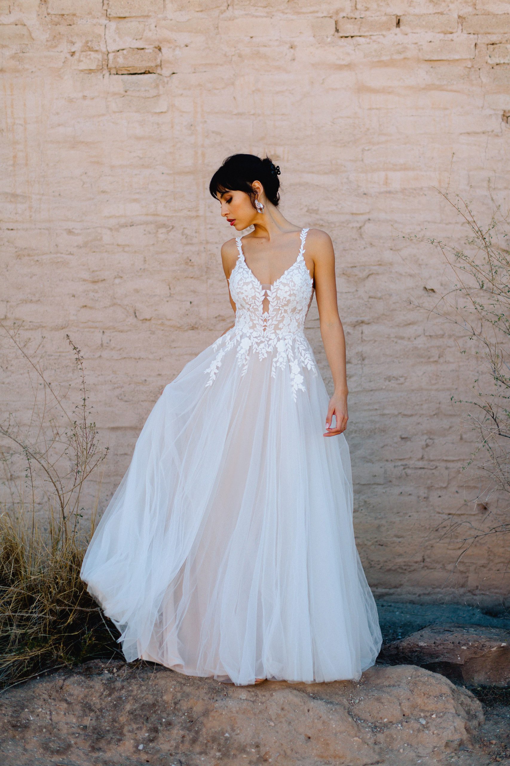 A Beautiful Feminine, Romantic and Lightweight Wedding Dress. Lace Sleeveless V-Neck Bodice with a Simple Flowy, super light, layered tulle A-Line Wedding Dress.  Featuring Buttons down the entire back/train. Low, detailed back adds the WOW.