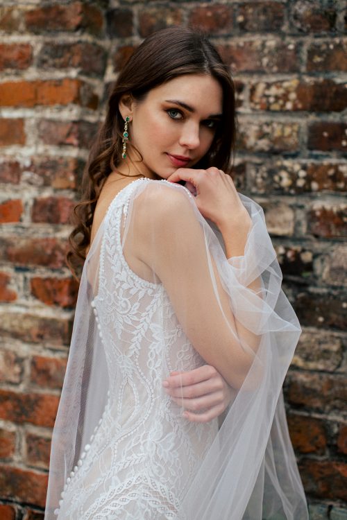 A Square Neck and High Backed Wedding Dress perfect for a Bride with Curves. The Champagne tones under the ivory lace give this dress a romantic and ethereal look and the sleeves can be removed.